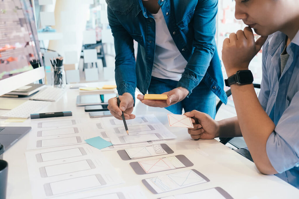 Two people designing user experience for a website.