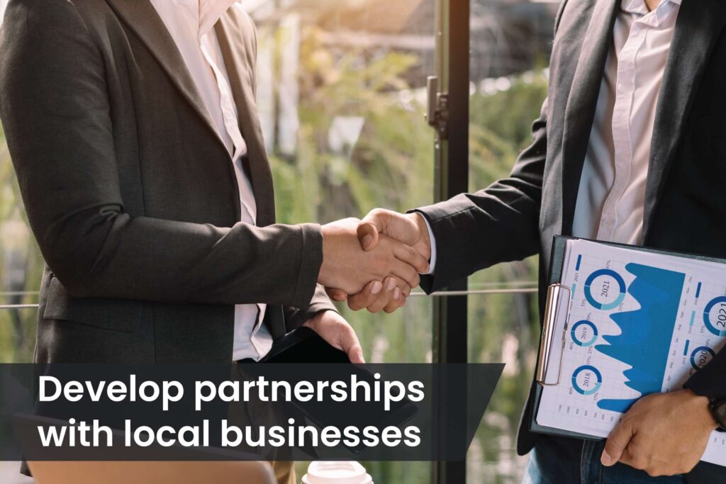 develop partnerships with local businesses- people shaking hands