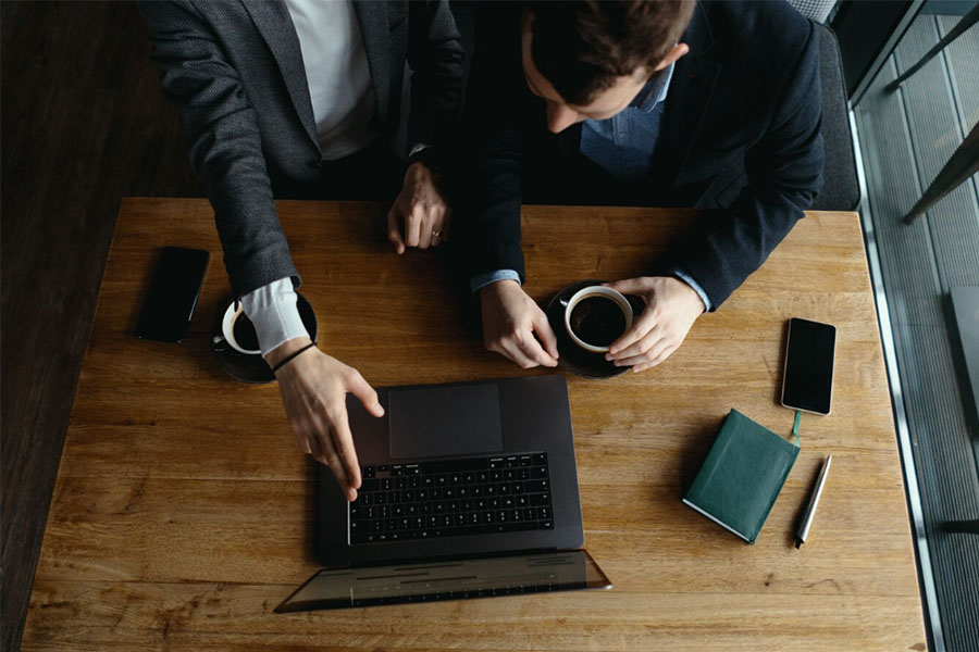 Two coworkers on an important meeting looking at the laptop.
